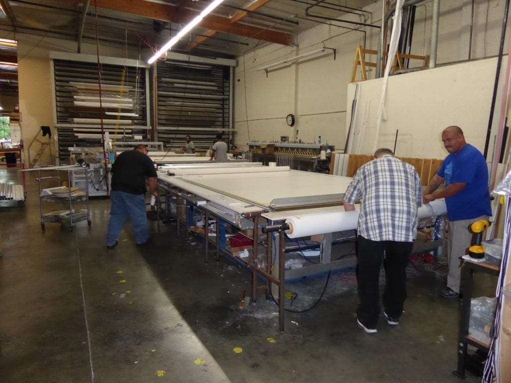 Guys working on roller shades in the shop