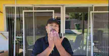 Steve using hand gestures to show double sliding screen door operation