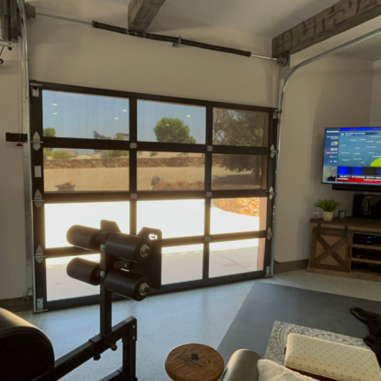 Interior View of Garage Screen Door. This garage was converted into a gym with weight bench, tv and a fridge converted from an old gas pump. Man cave for sure!