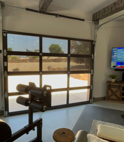 Interior View of Garage Screen Door. This garage was converted into a gym with weight bench, tv and a fridge converted from an old gas pump. Man cave for sure!